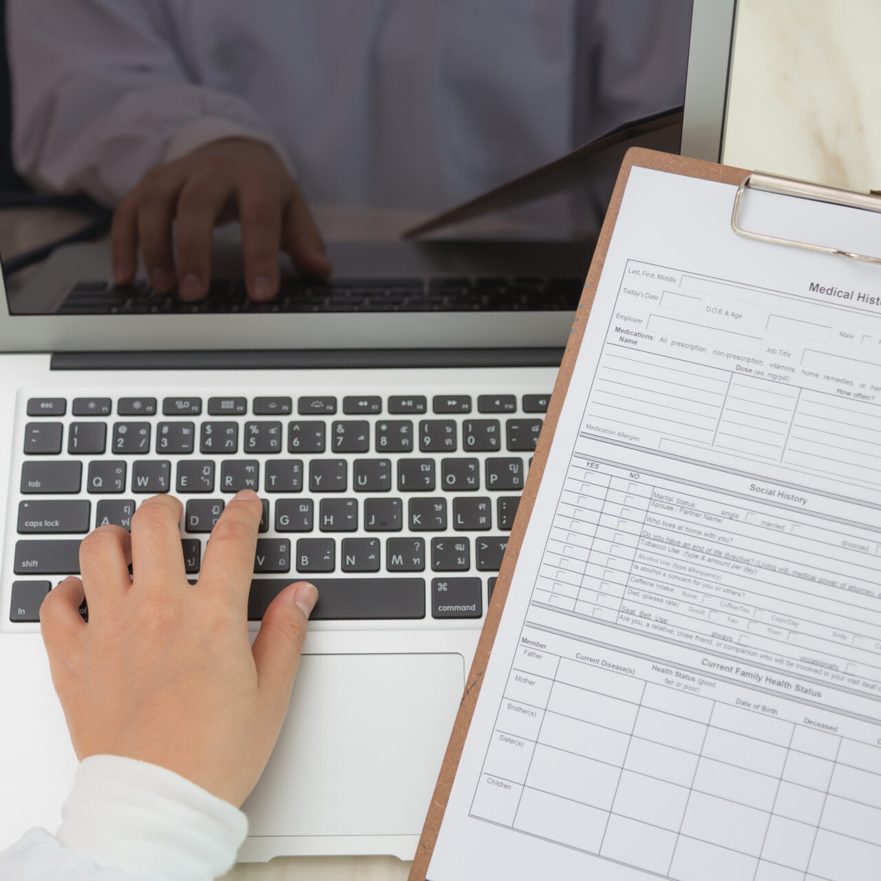 Doctor hands typing on laptop keyboard